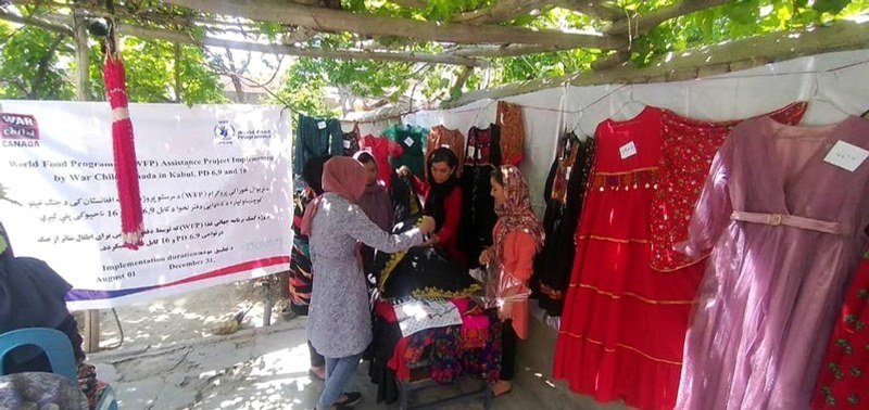 Women and locally made products at a market activity documented in ADVO’s materials